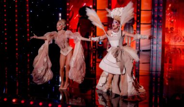 photo of two drag queens in architectural beige outfits and wigs performing on a stage