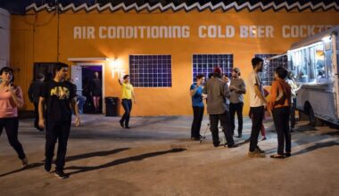 Outside of a property that reads Air conditioning , Cold beer