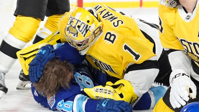 Boston Bruins goaltender Jeremy Swayman (1) takes down Tampa Bay Lightning left wing Brandon Hagel (38) during the second period of a Stadium Series NHL hockey game Sunday, Feb. 1, 2026, in Tampa, Fla.