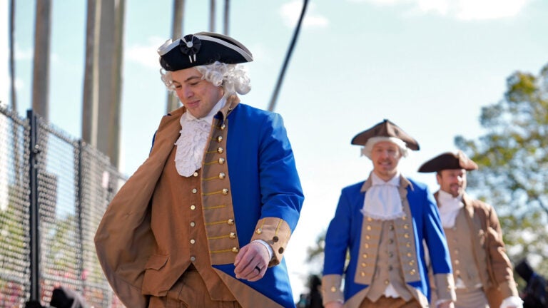 Boston Bruins players, wearing revolutionary war attire, arrive at the stadium before a Stadium Series NHL hockey game against the Tampa Bay Lightning Sunday, Feb. 1, 2026, in Tampa, Fla.