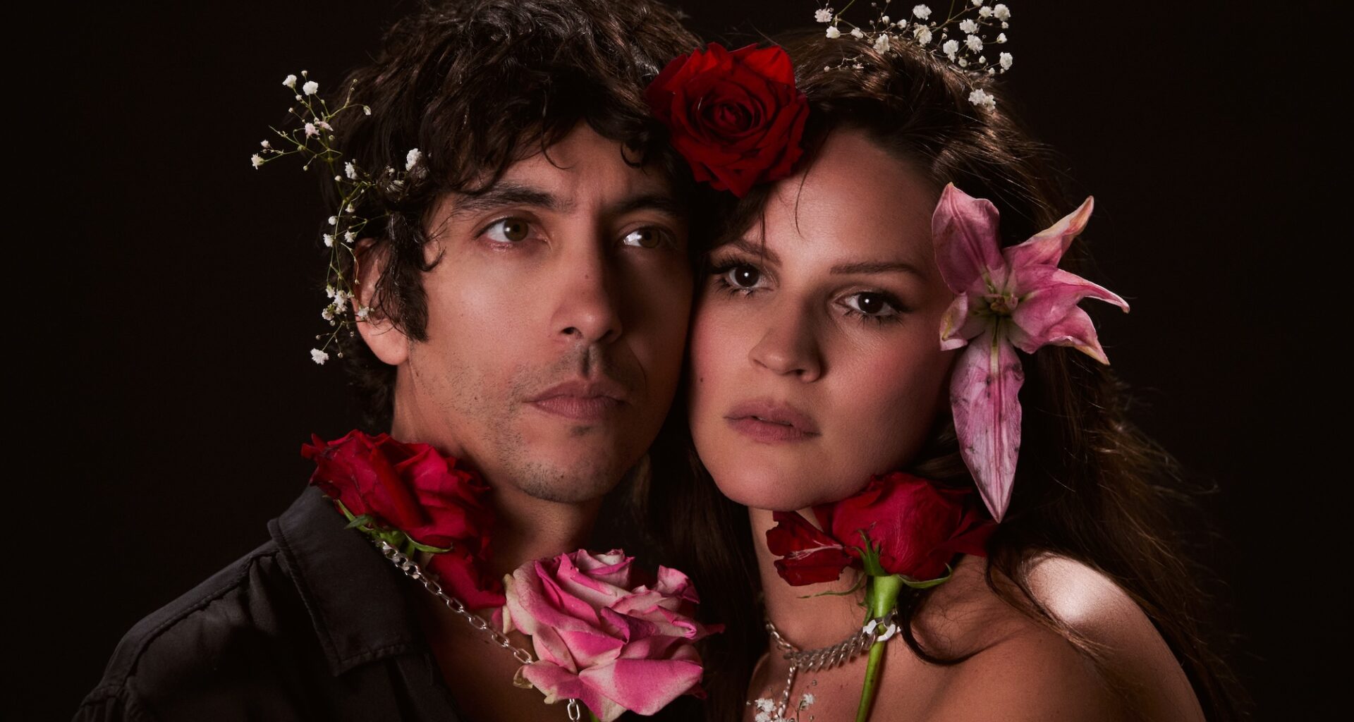Photo of a couple wearing real flowers