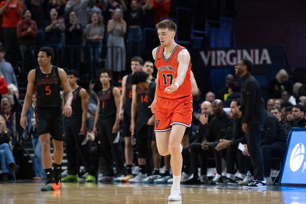 Virginia center Johann Grünloh (17) celebrates scoring 3-point shot against Miami during the...