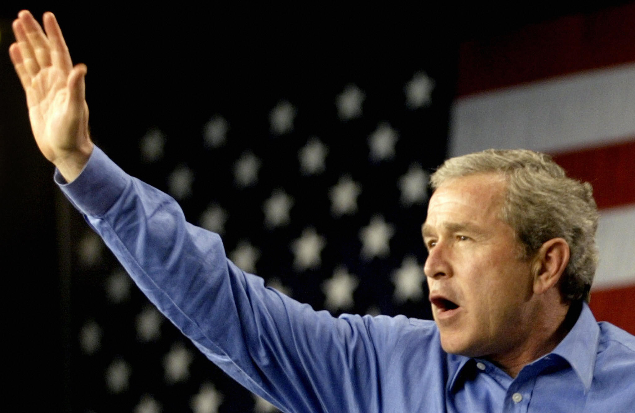 ORLANDO, UNITED STATES: US President George W. Bush waves to...