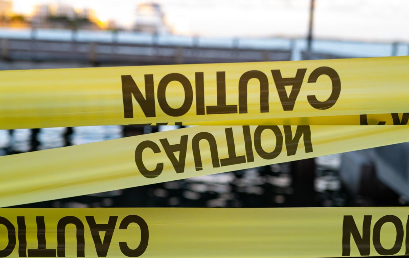 Yellow Caution USA Tape of COVID-19. Coronavirus Outbreak of Quarantine Area, Infection Virus Disease, Risk Area Zone. Biohazard. Lockdown quarantine. Miami Florida Closed. Health Protection Concept.