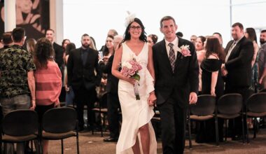 picture of Carissa Roldan in a wedding dress and Jason Nicholson in a suit getting married at the Leppa-Rattner Museum of Art