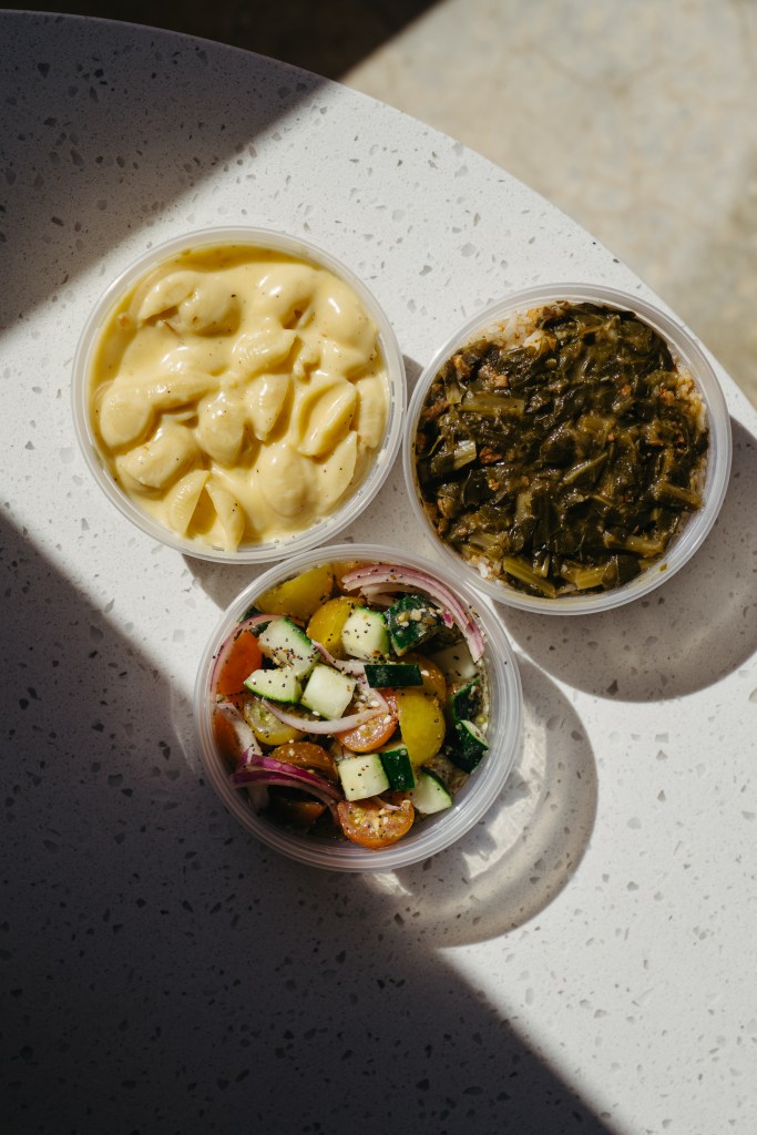 Gouda mac and cheese, collard greens, and cucumber at Chicken and Pig in Mulberry, FL. Local Southern comfort food sides at the Depot 303 food hall.