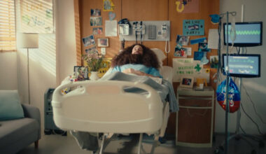 image of a hospital bed with a man laying in it with his eyes closed