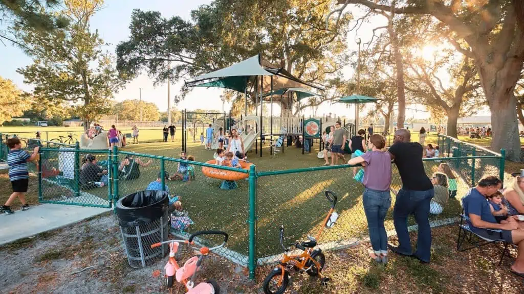 kids play on a playground on a sunny day during a community festival