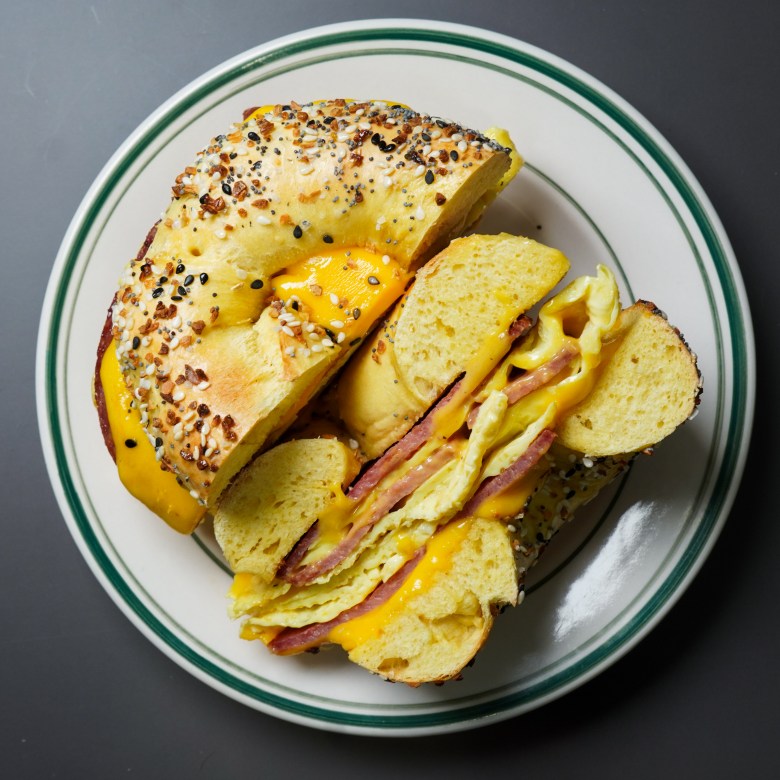Overhead view of a toasted everything bagel sandwich filled with folded eggs, melted cheese, and pork roll at Homesick Bagels in Tampa.