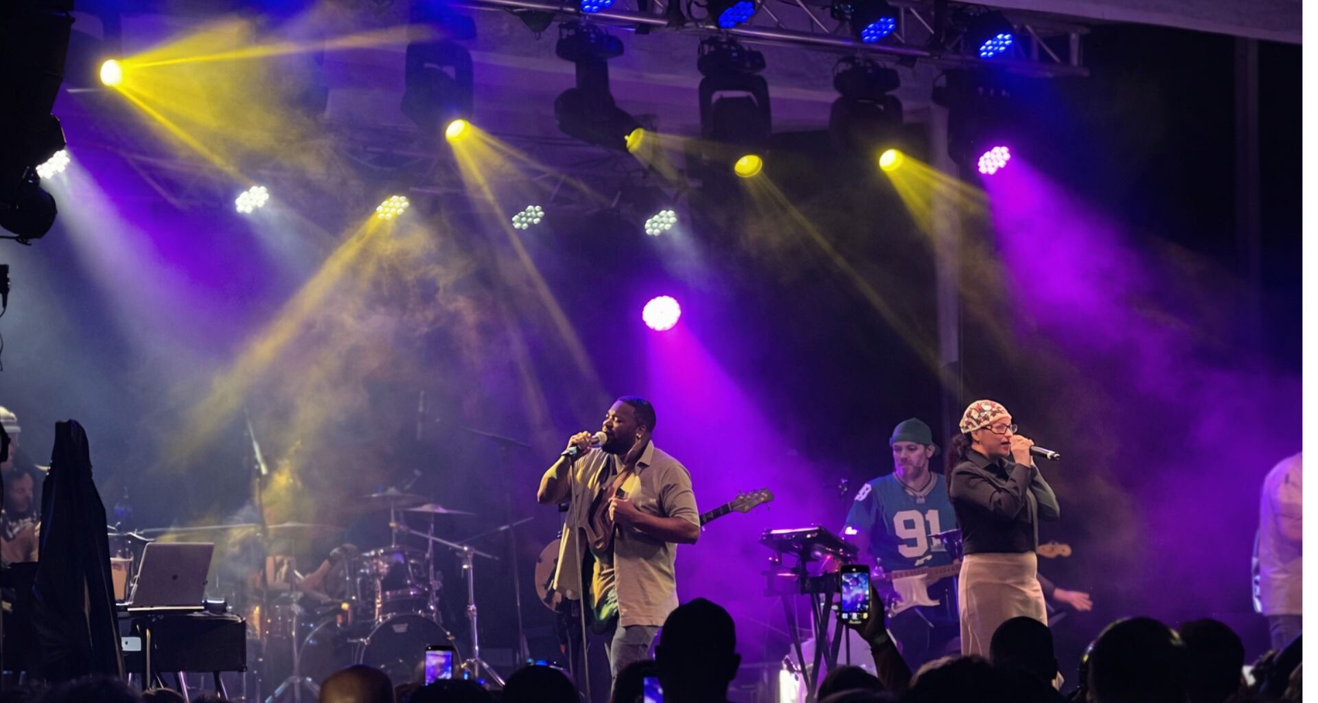 Photo of a band performing on a stage