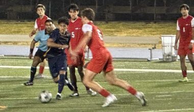 Downtown Doral’s Victor Villalobos (black jersey) battles through MAST’s defense on Tuesday during the Dolphins’ 4-0 win over the Makos in a Region 4-3A semifinal at Tropical Park.