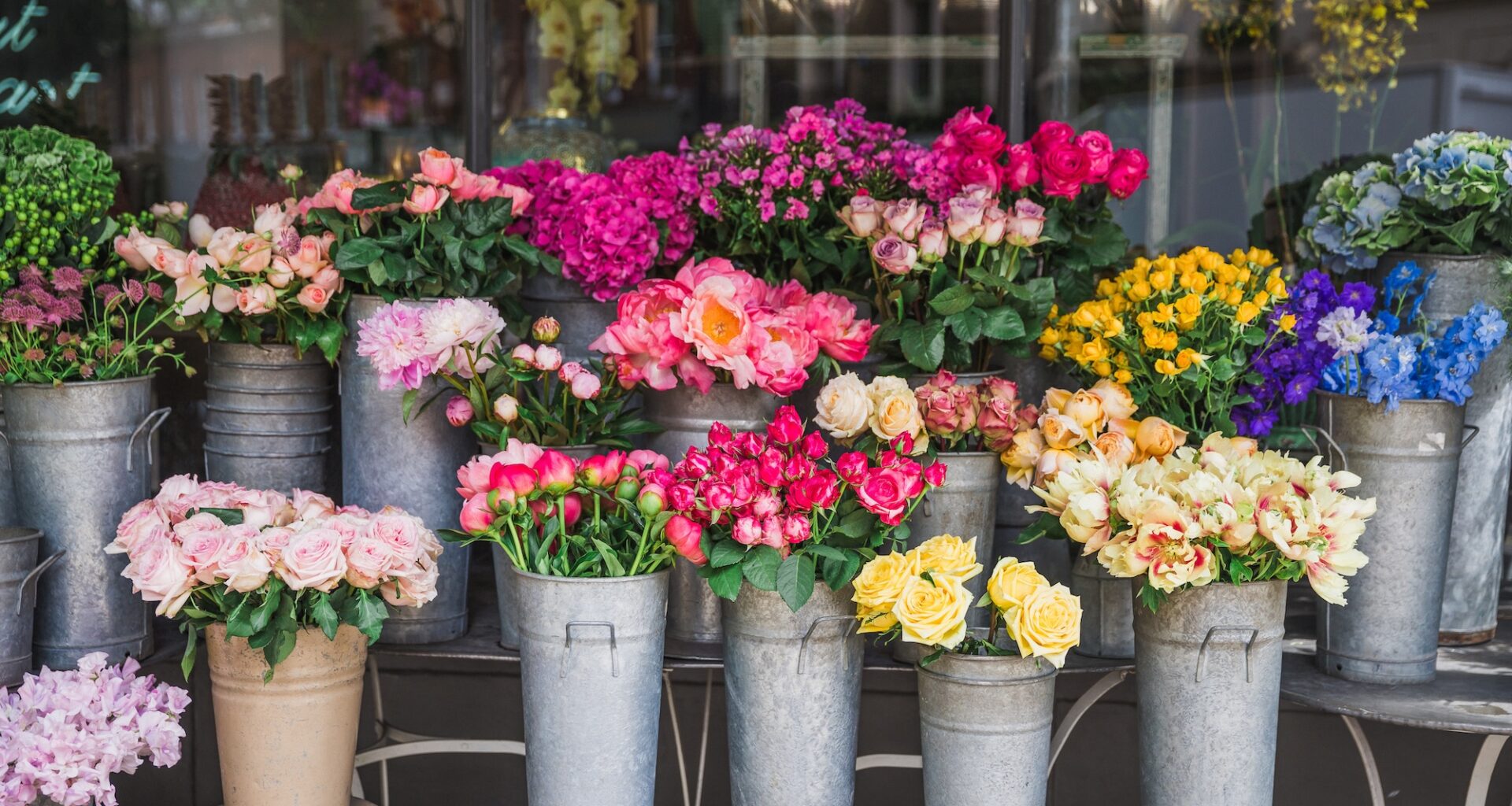 photo of flower arrangements in tin pots at a shop