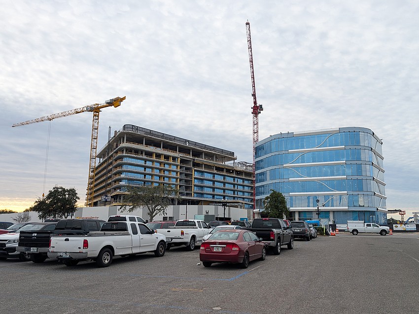 The Four Seasons Hotel and Private Residences, left, and One Tower Court office building are shown under construction in December 2025.