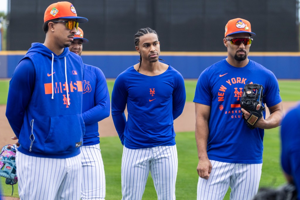 Left to right: Mark Vientos, Bo Bichette, Francisco Lindor and Marcus Semien listen to a coach during fielding practice at the Mets' training facility in Port St. Lucie on Feb. 17, 2026.