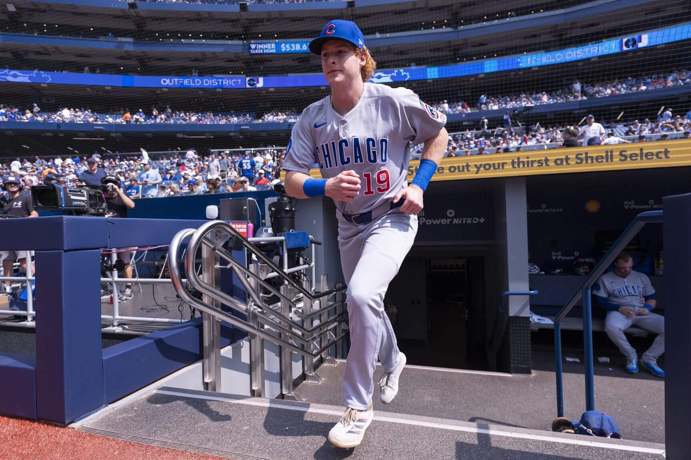 Owen Caissie of the Chicago Cubs, wearing No. 19 on his jersey, takes the field for warmups ahead of his major-league debut.