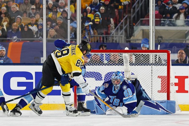 David Pastrnak of the Boston Bruins attempts a shot against Andrei Vasilevskiy of the Tampa Bay Lightning as Erik Cernak defends during the second period of the 2026 NHL Stadium Series at Raymond James Stadium on February 01, 2026 in Tampa, Florida. (Photo by Mike Carlson/Getty Images)