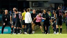 BAYAMON, PUERTO RICO - FEBRUARY 26: A kid is detained by security guards after jumping onto the field to greet Lionel Messi during a friendly game between Independiente del Valle and Inter Miami at Juan Ramón Loubriel stadium on February 26, 2026 in Bayamon, Puerto Rico. (Photo by Leopoldo Smith/Getty Images)