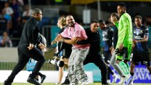 BAYAMON, PUERTO RICO - FEBRUARY 26: A fan is detained by security guards after jumping onto the field to greet Lionel Messi during a friendly game between Independiente del Valle and Inter Miami at Juan Ramón Loubriel stadium on February 26, 2026 in Bayamon, Puerto Rico. (Photo by Leopoldo Smith/Getty Images)