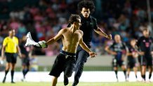 BAYAMON, PUERTO RICO - FEBRUARY 26: A fan is chased by security guards after jumping onto the pitch to greet Lionel Messi during a friendly game between Independiente del Valle and Inter Miami at Juan Ramón Loubriel stadium on February 26, 2026 in Bayamon, Puerto Rico. (Photo by Leopoldo Smith/Getty Images)