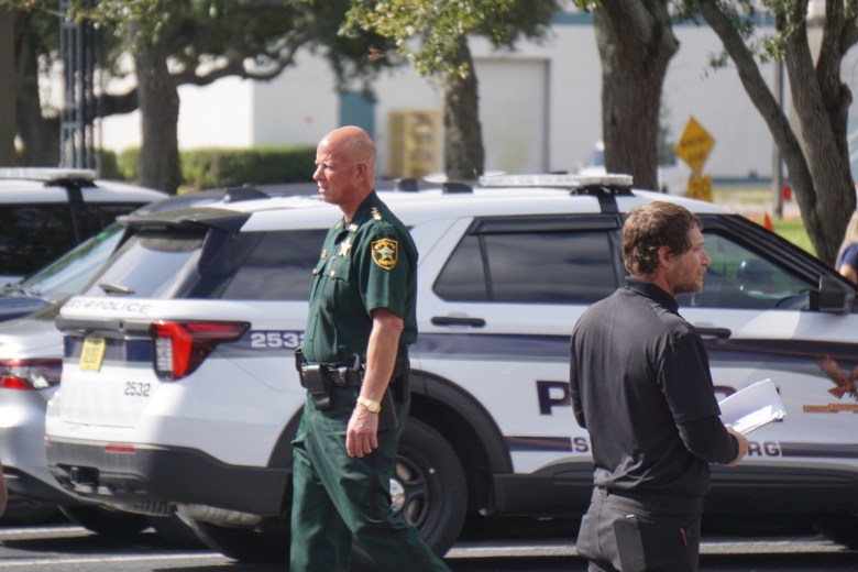 Pinellas County law enforcement monitoring a public protest outside a U.S. Customs and Border Protection recruitment event in St. Petersburg, Florida.