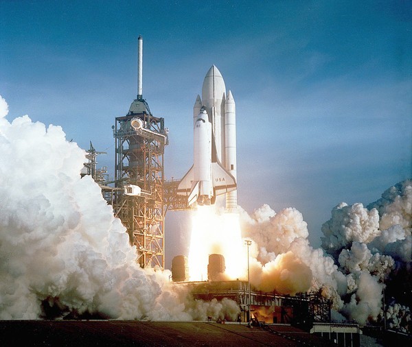 NASA's Space Shuttle Columbia (STS-1) rises above Launch Complex 39's...