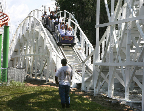 A workman studies the ride as employees test the track...
