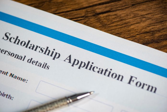 Scholarship application form document contract concept with pen