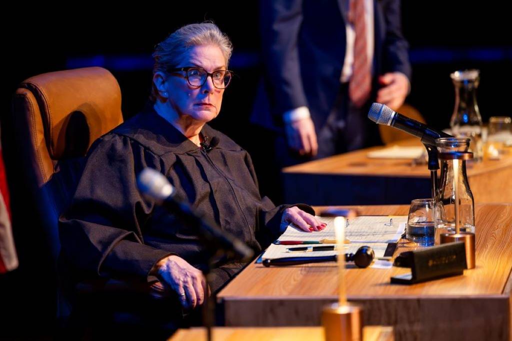 woman looks shocked as she plays judge in the jury experience