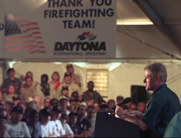 President Clinton talks to assembled firefighters at the Daytona International Speedway on Thursday, July 9, 1998. Clinton made a stop in Daytona Beach to meet with those firefighters who fought the Florida wildfires and to meet with people af(ected by the fires. AP file