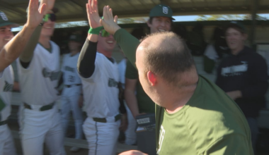 Longtime Thomas University scoreboard operator throws out first pitch