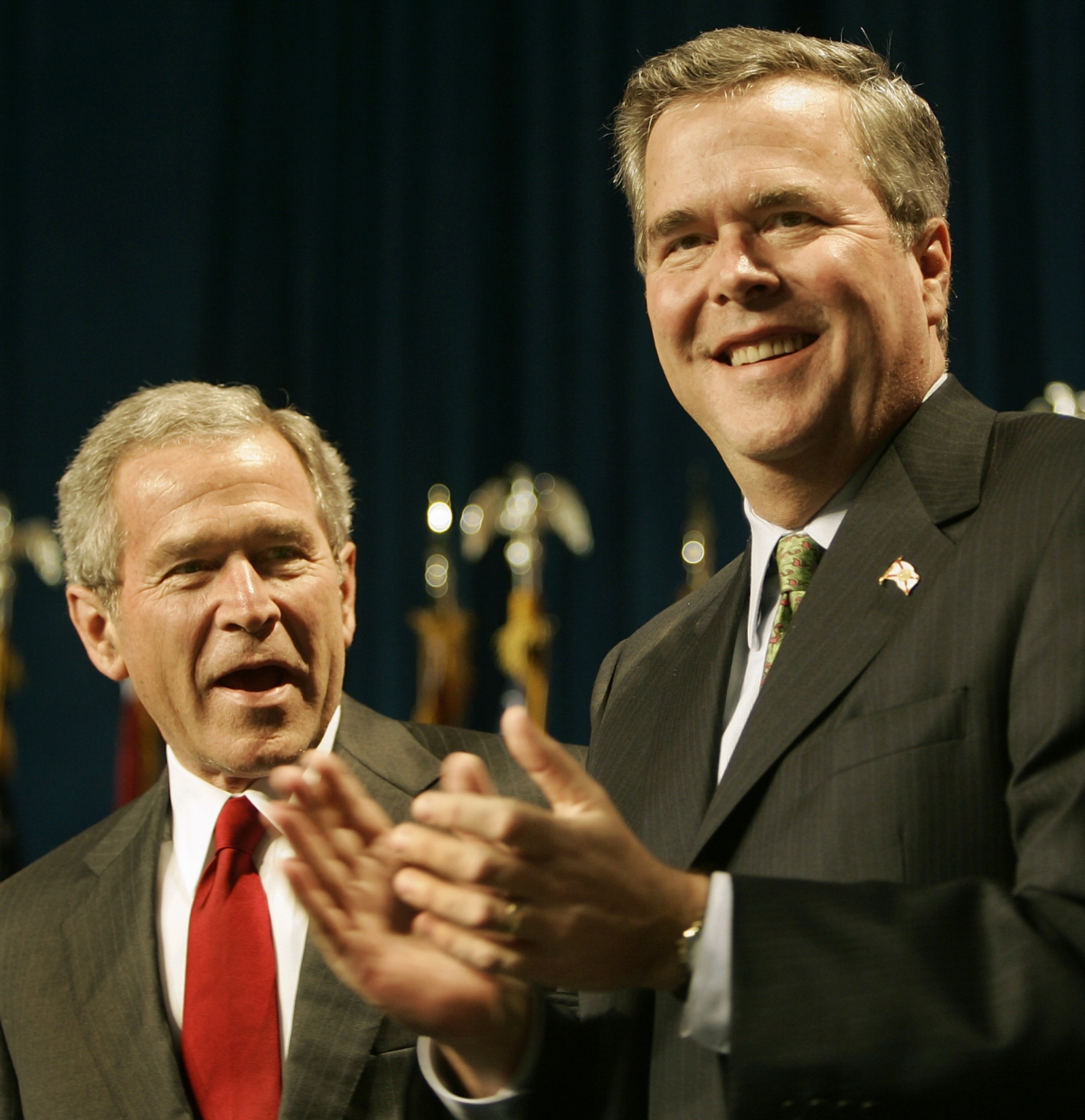 US President George W. Bush (L) is introduced by his...