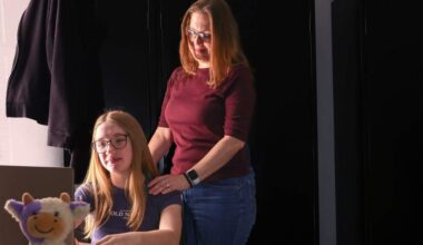 Christina Underwood, right, stands over her 13-year-old daughter Harper's shoulder as they recall her medical emergency and nearby hospitals rejecting her Florida Blue insurance coverage on Thursday, February 12, 2026, in Fort Lauderdale, Florida. The stuffedd colorful cow, left, was a gift from Christina to her daughter, and she travels with it often as a reminder of her mother's love and support.
