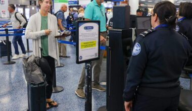 A traveler holds travel documents in hand (not needed) as she is processed through the Toucheless ID security checkpoint as Miami International Airport, along with American Airlines and the Transportation Security Administration, hosted a press conference to discuss the availability of TSA PreCheck® Touchless ID at MIA Door 1 in Departures on Tuesday, February 10, 2026, in Miami, Florida.