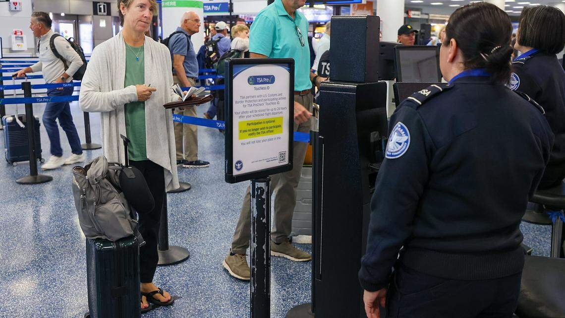 A traveler holds travel documents in hand (not needed) as she is processed through the Toucheless ID security checkpoint as Miami International Airport, along with American Airlines and the Transportation Security Administration, hosted a press conference to discuss the availability of TSA PreCheck® Touchless ID at MIA Door 1 in Departures on Tuesday, February 10, 2026, in Miami, Florida.