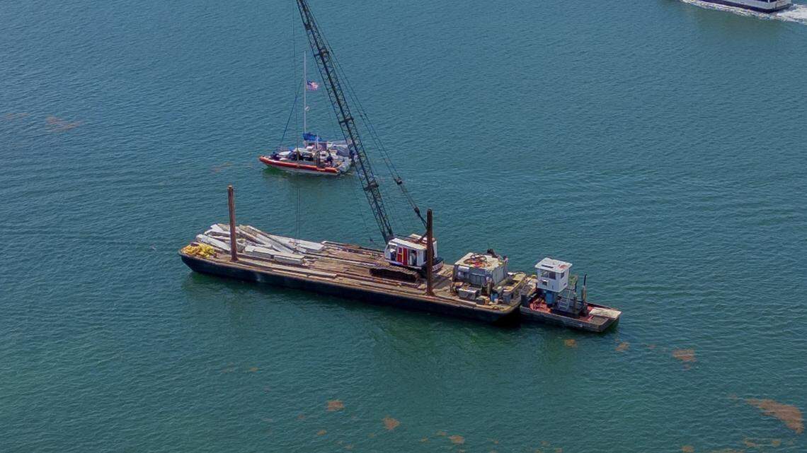 View of a 60-foot barge that hit a 17-foot sailboat that sank off Miami Beach’s Hibiscus Island in Biscayne Bay Monday morning, July 28, 2025. Five children and a camp counselor were aboard the sailboat, part of a Miami Yacht Club summer camp. Three girl campers died and two were injured in the crash.  The parents of the three girls who died have filed suit against the barge owner.