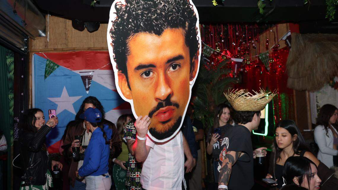 A fan carries a giant Bad Bunny head through The Dead Flamingo bar, which hosted a watch party for the Puerto Rican star’s halftime show.