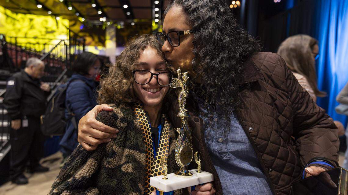 Maxine Williams kisses her son, Lancaster Gramer, 14, an eighth grader from Franklin Academy Cooper City, after he won the 86th Miami Herald Spelling Bee for Broward County at the Charles F. Dodge City Center on Wednesday, Feb. 25, 2026, in Pembroke Pines, Fla. Gramer won the competition after correctly spelling the winning word, californium.
