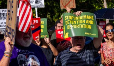 Demonstrators wave signs that read “STOP INHUMANE DETENTION AND DEPORTATION” during a press conference hosted by ACLU Florida, Florida Rising, The Florida Immigrant Coalition and Family Action Network Movement on Tuesday, June 17, 2025, in Miami.