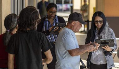 Staff from the Miami Dade Tax Collector’s office help people with their appointments as they arrive at a driver license office on Tuesday, Feb. 10, 2026, in Hialeah Gardens. As of Feb. 6, 2026, the Florida Department of Highway Safety and Motor Vehicles requires all driver license knowledge and skills examinations to be conducted exclusively in English.