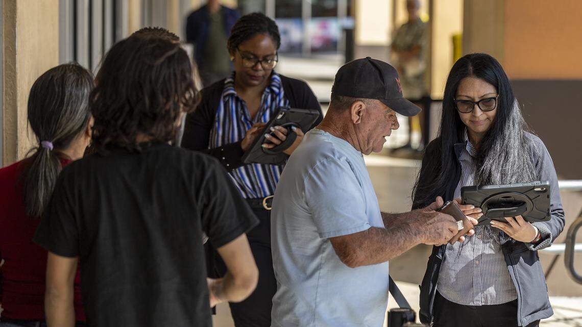 Staff from the Miami Dade Tax Collector’s office help people with their appointments as they arrive at a driver license office on Tuesday, Feb. 10, 2026, in Hialeah Gardens. As of Feb. 6, 2026, the Florida Department of Highway Safety and Motor Vehicles requires all driver license knowledge and skills examinations to be conducted exclusively in English.