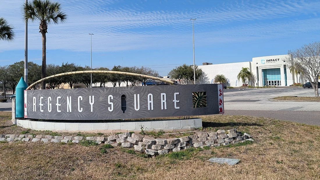 The Regency Square mall sign with the Impact Chrucy building in the background