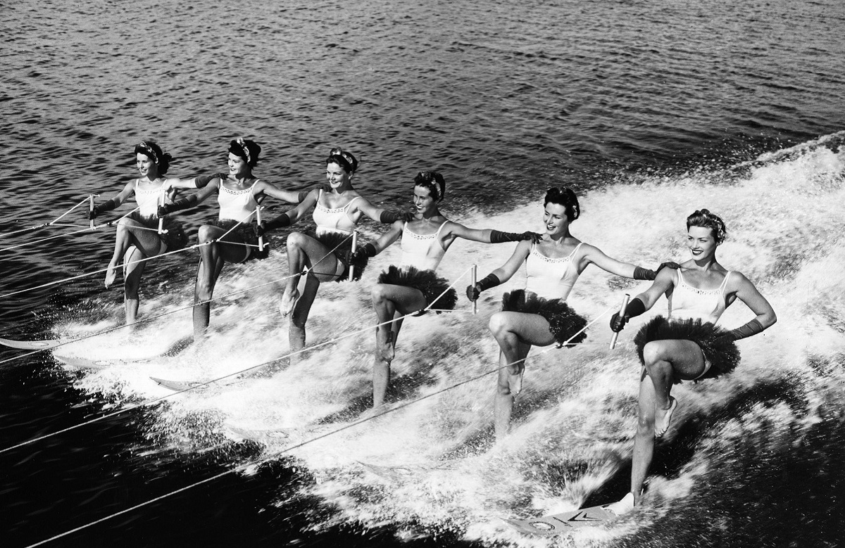 A group of women water ski in formation at Florida's...