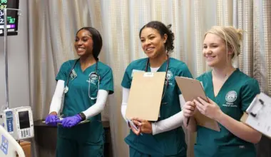 Three nursing students in scrubs