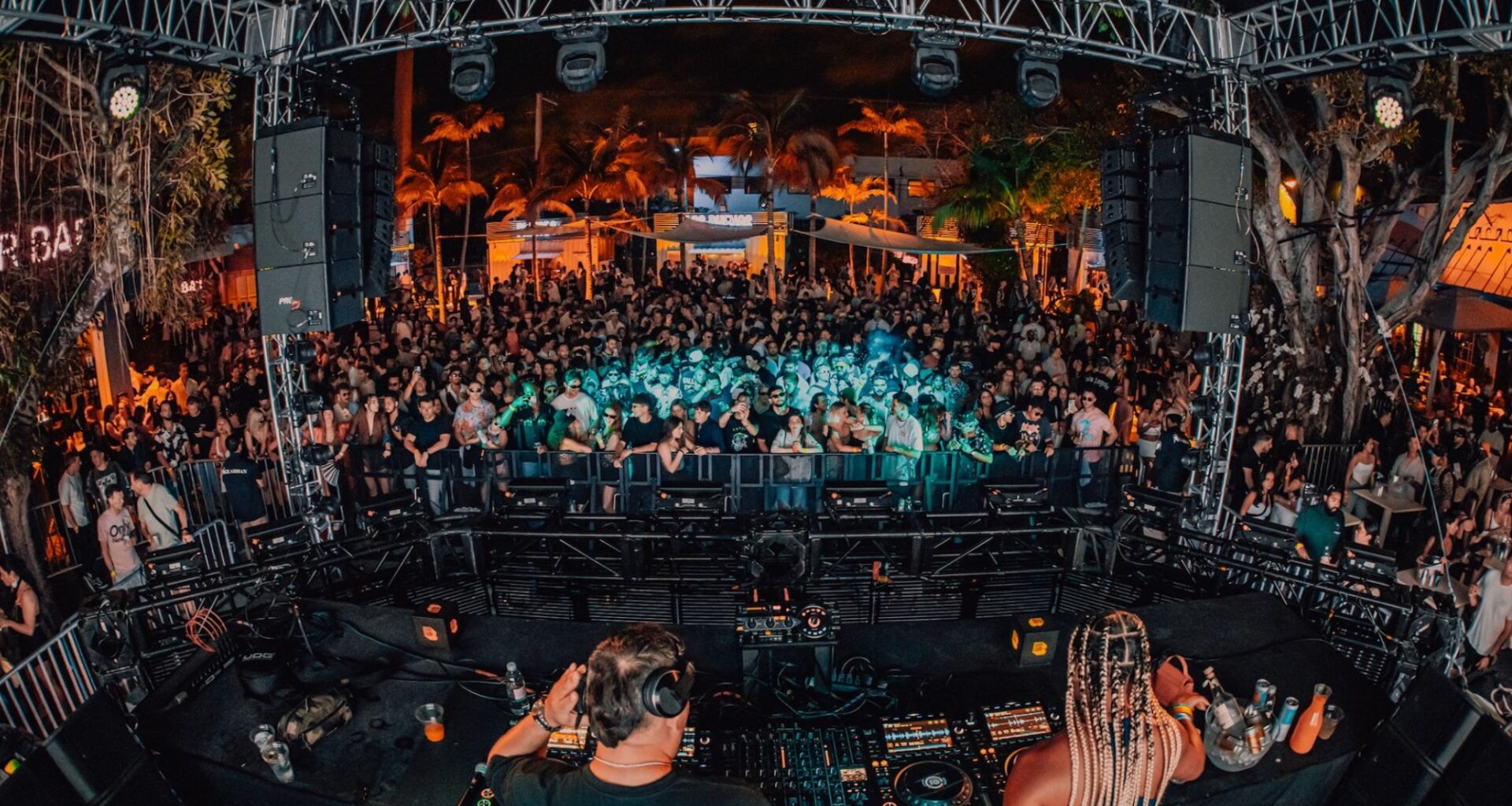 Photo of a stage at a venue full of people