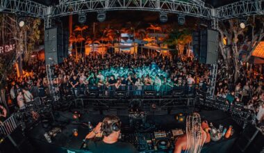 Photo of a stage at a venue full of people