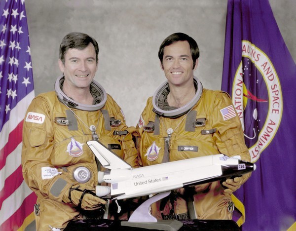 STS-1 crew members Commander John Young (L) and Pilot Robert...