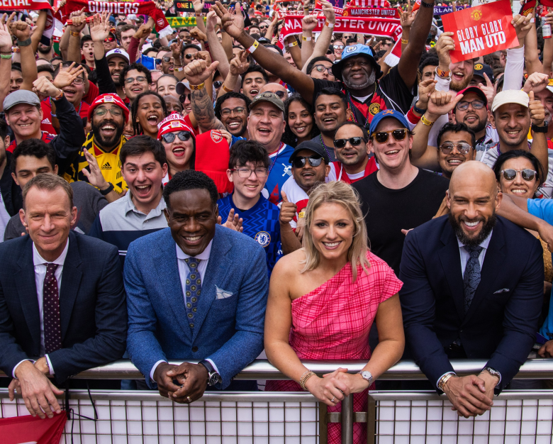Premier League Fan Fest Orlando at Universal Orlando Resort. NBC Sports studio team Rebecca Lowe, Tim Howard, and the two Robbies with fans holding "Glory Glory Man Utd" and "Gunners" signs. Soccer fan event coverage for NBC Sports and Premier League USA.