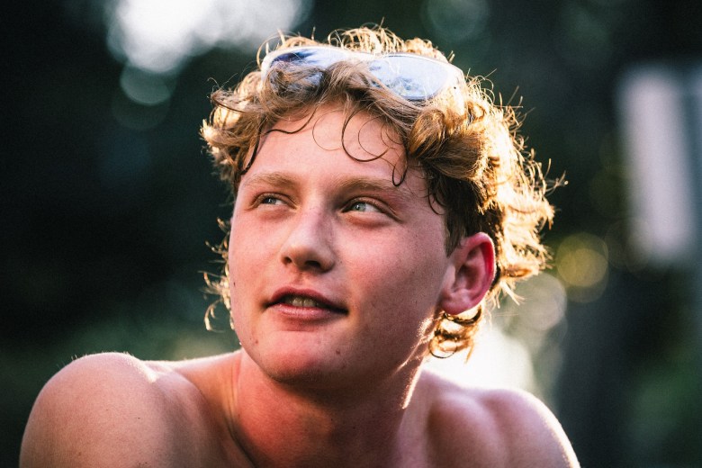 Plant High School runner Ethan Gear looking upward during a break from track and field practice at Fred Ball Park in Tampa.