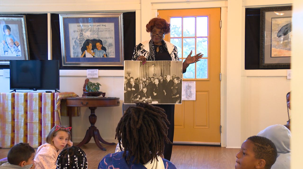 Odessa Butler speaking to a student group at the Reid House