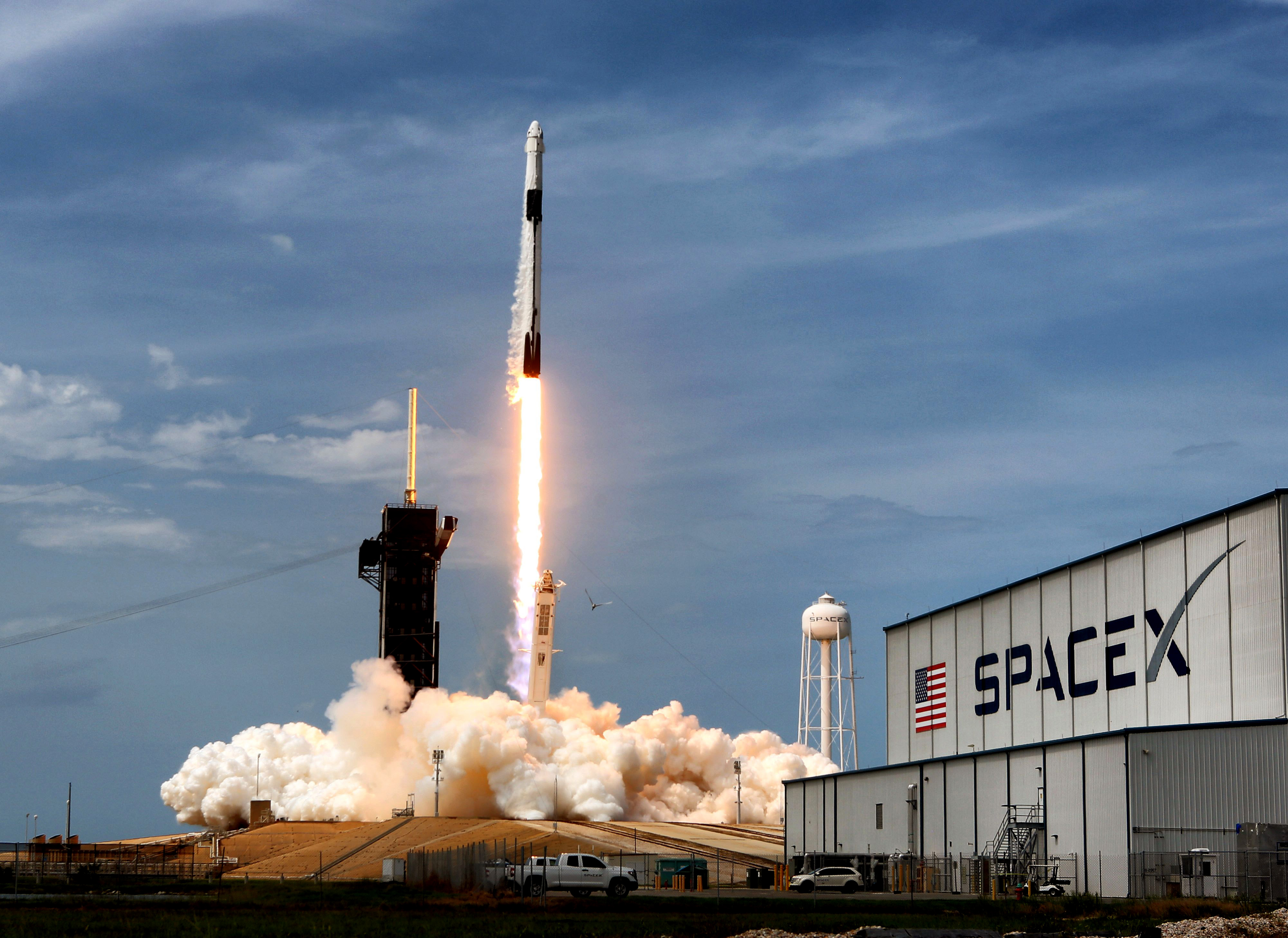 The SpaceX Falcon 9 rocket carrying astronauts Doug Hurley and...